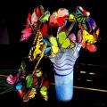 Papillons multicolores sur tige 24 cm x 10 pièces